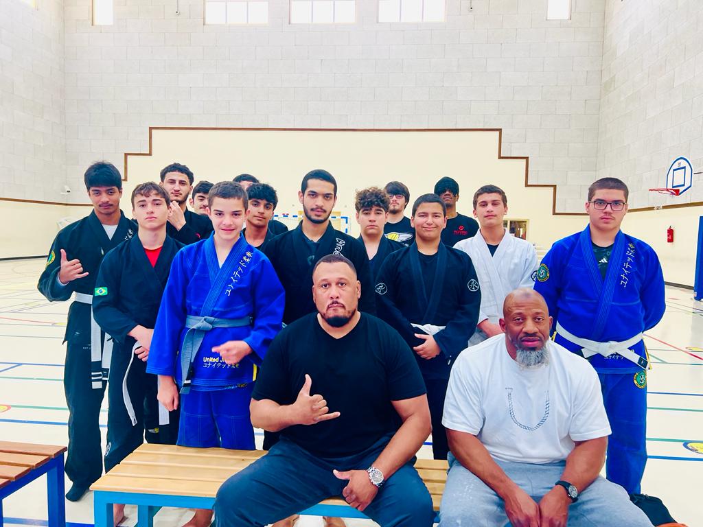 United BJJ AZ students and coaches together on the mat after class.