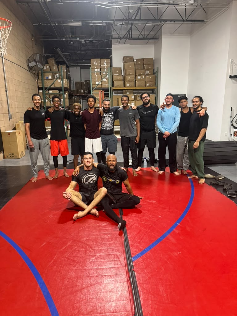 An adult class gathered on the mat at United BJJ AZ.